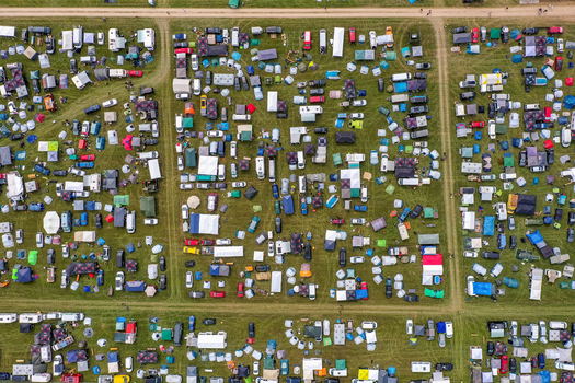 Aerial view of the Open Beatz Festival camping area with numerous tents and vehicles parked on green fields in Herzogenaurach Bayern Germany. Aerial view of the Open Beatz Festival camping area with numerous tents and vehicles parked on green fields in Herzogenaurach Bayern Germany.