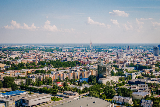 Riga Latvia 25 May 2014 Aerial view of the modern Skanste district and the historic Riga city skyline featuring high rise buildings residential blocks and the distant TV tower.