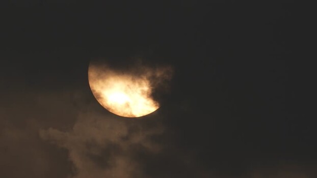 View of the sun partially obscured by dark clouds Bangladesh. View of the sun partially obscured by dark clouds Bangladesh.