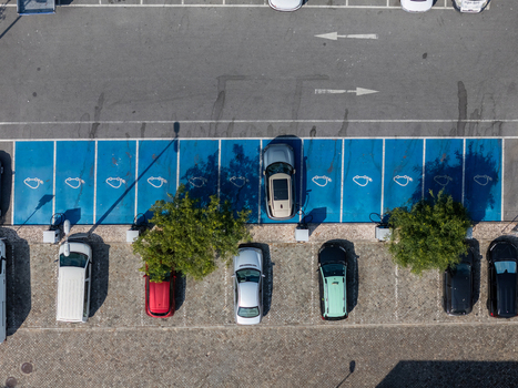 Aerial view of electric car charging station with parked vehicles in a parking lot in Alges Lisbon Portugal.
