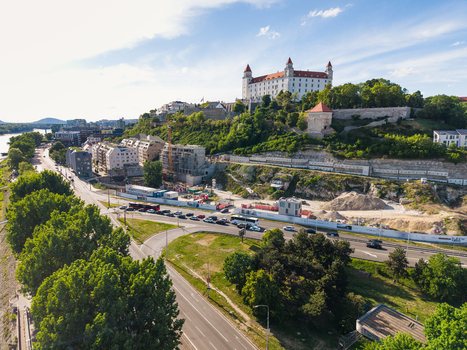 Aerial view of Bratislava Castle on a lush green hill overlooking the city streets and modern architecture in Bratislava Bratislava Region Slovakia. Aerial view of Bratislava Castle on a lush green hill overlooking the city streets and modern architecture in Bratislava Bratislava Region Slovakia.