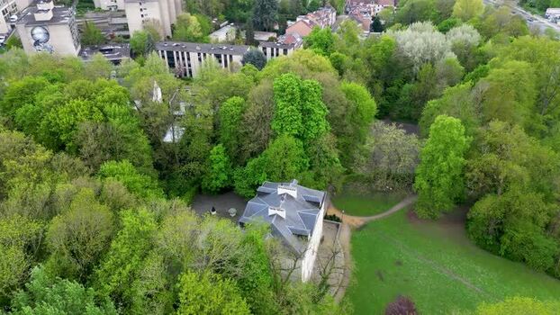 Aerial view of a historic building surrounded by lush green trees Belgium Aerial view of a historic building surrounded by lush green trees Belgium