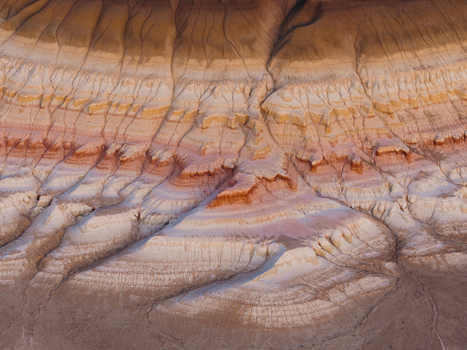 Aerial view of colorful layered geological formations and eroded ridges in the desert landscape of Mangystau Region Kazakhstan. Aerial view of colorful layered geological formations and eroded ridges in the desert landscape of Mangystau Region Kazakhstan.