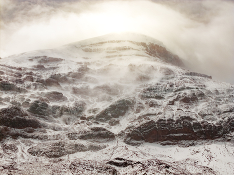 Aerial view of Volcano Chimborazo with snow covered rocky slopes and swirling clouds at the summit in Guano Chimborazo Ecuador. Aerial view of Volcano Chimborazo with snow covered rocky slopes and swirling clouds at the summit in Guano Chimborazo Ecuador.