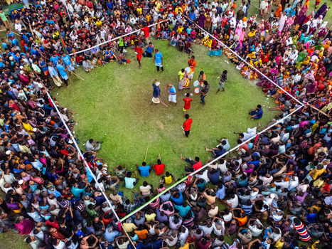 Nilphamari Bangladesh 01 May 2026 Aerial view of a traditional stick dance performance in a grassy arena surrounded by a large colorful crowd of spectators. Nilphamari Bangladesh 01 May 2026 Aerial view of a traditional stick dance performance in a grassy arena surrounded by a large colorful crowd of spectators.