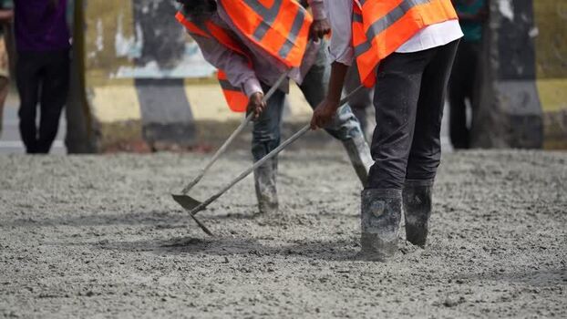 View of construction workers leveling wet concrete in Dhaka Bangladesh. View of construction workers leveling wet concrete in Dhaka Bangladesh.
