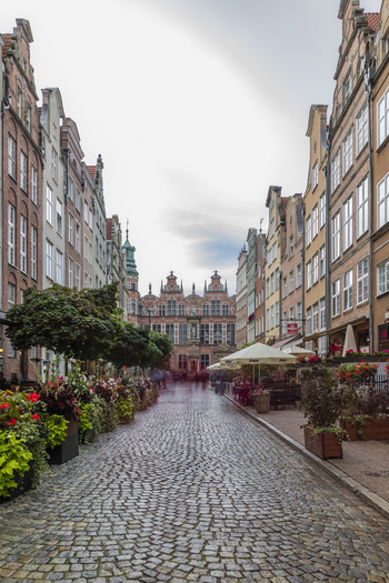 Gdansk Poland 05 September 2026 View of the historic Mariacka Street with its iconic cobblestone pavement colorful townhouses and outdoor cafe seating under an overcast sky. Gdansk Poland 05 September 2026 View of the historic Mariacka Street with its iconic cobblestone pavement colorful townhouses and outdoor cafe seating under an overcast sky.