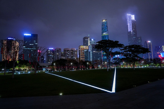 Guangzhou China 24 February 2024 View of the illuminated Guangzhou skyline at night with glowing ground lines in the park and modern skyscrapers under a dark sky. Guangzhou China 24 February 2024 View of the illuminated Guangzhou skyline at night with glowing ground lines in the park and modern skyscrapers under a dark sky.