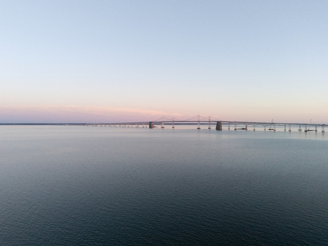 Aerial view of the Chesapeake Bay Bridge spanning across calm water under a soft twilight sky Annapolis Maryland United States. Aerial view of the Chesapeake Bay Bridge spanning across calm water under a soft twilight sky Annapolis Maryland United States.