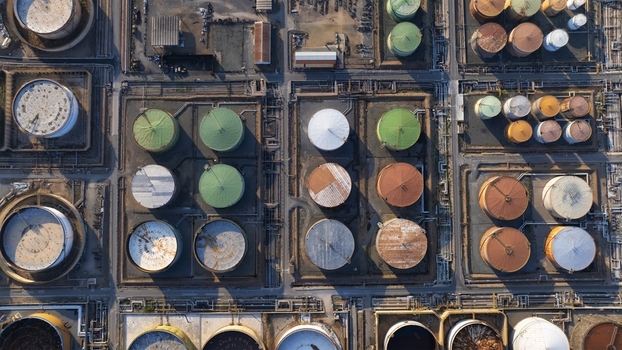 Aerial view of colorful industrial storage tanks and complex pipeline infrastructure at a refinery facility in Cagliari Sardinia Italy. Aerial view of colorful industrial storage tanks and complex pipeline infrastructure at a refinery facility in Cagliari Sardinia Italy.