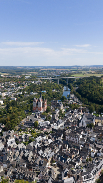 Aerial view of Limburg Cathedral surrounded by historic half timbered houses the Lahn river and a modern bridge in Limburg an der Lahn Hessen Germany. Aerial view of Limburg Cathedral surrounded by historic half timbered houses the Lahn river and a modern bridge in Limburg an der Lahn Hessen Germany.