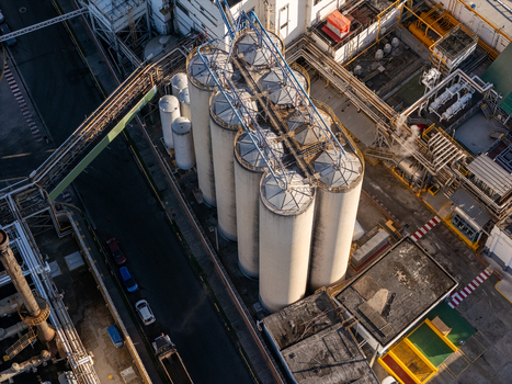 Aerial view of the beer industrial complex featuring large cylindrical storage silos intricate piping systems and industrial infrastructure in Santo Domingo Dominican Republic. Aerial view of the beer industrial complex featuring large cylindrical storage silos intricate piping systems and industrial infrastructure in Santo Domingo Dominican Republic.