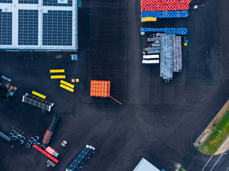 Aerial view of a manufacturing facility for polymer pipe systems featuring organized stacks of colorful pipes industrial storage and a building with solar panels in Jelgava Latvia. Aerial view of a manufacturing facility for polymer pipe systems featuring organized stacks of colorful pipes industrial storage and a building with solar panels in Jelgava Latvia.