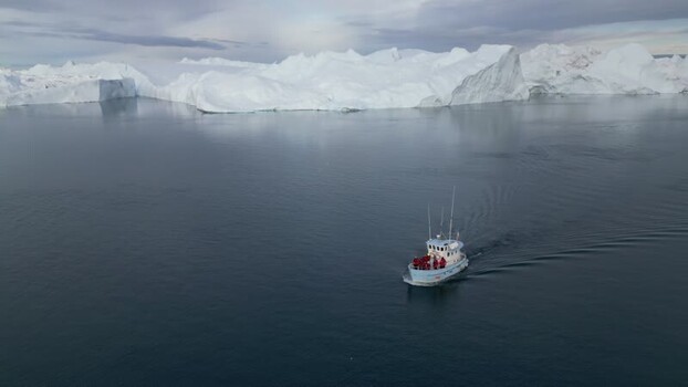 Aerial view of boat navigating near Ilulissat icebergs Greenland. Aerial view of boat navigating near Ilulissat icebergs Greenland.