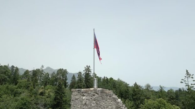 Aerial view of Liechtenstein flag on stone ruins Liechtenstein.