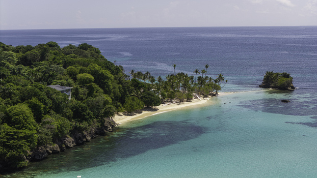 Aerial view of Cayo Levantado Beach with lush tropical vegetation white sand and turquoise waters in the Caribbean Sea in Samana SAMANA Dominican Republic. Aerial view of Cayo Levantado Beach with lush tropical vegetation white sand and turquoise waters in the Caribbean Sea in Samana SAMANA Dominican Republic.