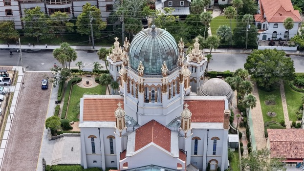 Aerial view of Memorial Presbyterian Church with its distinctive copper dome terracotta roof tiles and surrounding manicured gardens in St. Augustine Florida United States.