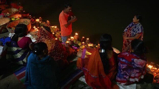 View of people performing a religious ritual by the river Bangladesh. View of people performing a religious ritual by the river Bangladesh.