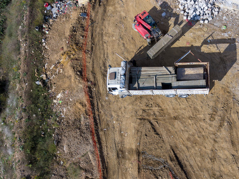 Aerial view of a truck loaded with construction materials parked on a dirt site next to heavy machinery in Istanbul Istanbul Turkiye.