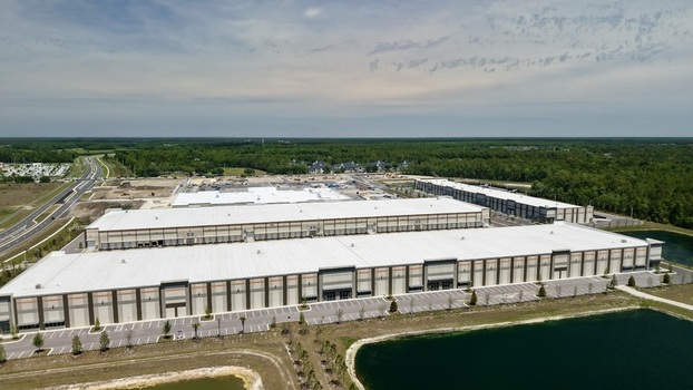 Aerial view of large industrial warehouses and distribution centers with loading docks and parking lots near Saint Johns Parkway World Golf Village Florida United States. Aerial view of large industrial warehouses and distribution centers with loading docks and parking lots near Saint Johns Parkway World Golf Village Florida United States.