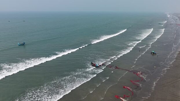 Aerial view of fishermen pulling a red net at Cox s Bazar Bangladesh. Aerial view of fishermen pulling a red net at Cox s Bazar Bangladesh.