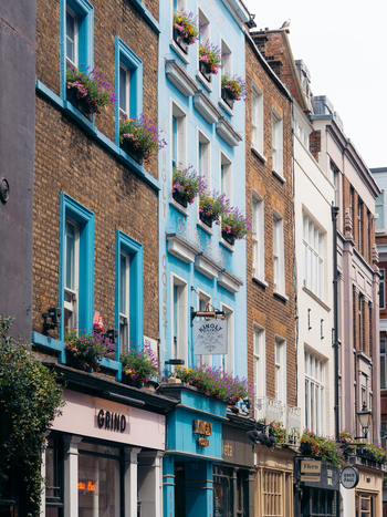 London United Kingdom 20 June 2025 View of vibrant buildings displaying a colorful facade with flowers adding to the charm of the urban scene. London United Kingdom 20 June 2025 View of vibrant buildings displaying a colorful facade with flowers adding to the charm of the urban scene.