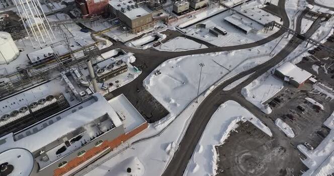 Aerial view of an industrial facility covered in snow United States. Aerial view of an industrial facility covered in snow United States.