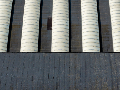 Aerial view of the repeating cylindrical roof structures of an old factory in Plock Mazowieckie Poland. Aerial view of the repeating cylindrical roof structures of an old factory in Plock Mazowieckie Poland.