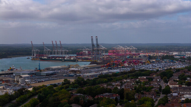 Aerial view of the busy Port of Southampton with large container ships towering cranes and rows of shipping containers in Southampton England United Kingdom. Aerial view of the busy Port of Southampton with large container ships towering cranes and rows of shipping containers in Southampton England United Kingdom.