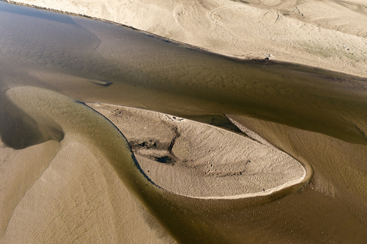 Aerial view of Zawadowskie Islands Nature Reserve featuring sandy riverbanks and shallow water patterns in Masovian Voivodeship Poland.