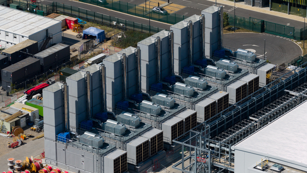 Aerial view of the Kao Data facility featuring large industrial cooling units and HVAC systems on the roof in Harlow England United Kingdom. Aerial view of the Kao Data facility featuring large industrial cooling units and HVAC systems on the roof in Harlow England United Kingdom.