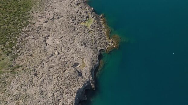 Aerial view of the rugged rocky coastline of Plemmirio Italy.