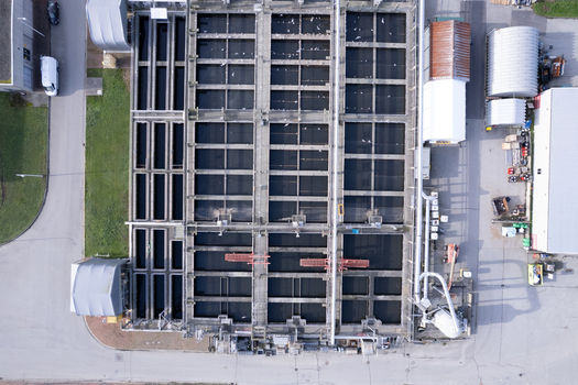 Aerial view of the waste water treatment facility featuring large rectangular sedimentation tanks and industrial infrastructure in Richmond British Columbia Canada. Aerial view of the waste water treatment facility featuring large rectangular sedimentation tanks and industrial infrastructure in Richmond British Columbia Canada.