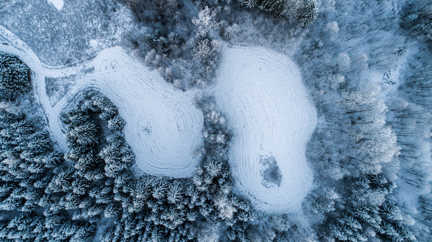 Aerial view of snow covered forest and fields in winter in Latvia. Aerial view of snow covered forest and fields in winter in Latvia.