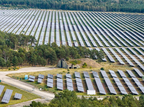 Aerial view of the former Military Airfield Preschen now a large solar farm with rows of panels historic hangars and runway remnants in Neisse Malxetal Brandenburg Germany. Aerial view of the former Military Airfield Preschen now a large solar farm with rows of panels historic hangars and runway remnants in Neisse Malxetal Brandenburg Germany.