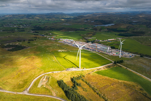 Aerial view of Green Mountain SVG Undheim Datasenter and wind turbines set in the rolling green hills and rural landscape of Undheim Rogaland Norway. Aerial view of Green Mountain SVG Undheim Datasenter and wind turbines set in the rolling green hills and rural landscape of Undheim Rogaland Norway.