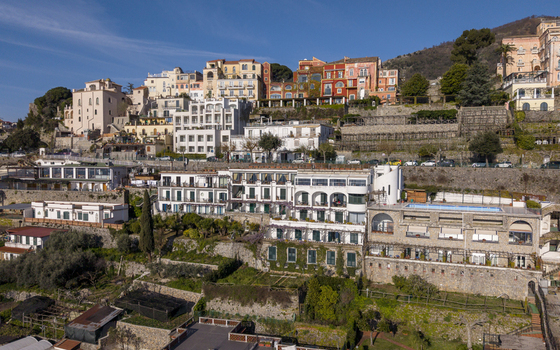 Aerial view of sun drenched buildings cascade down the hillside a mix of vibrant colours and architectural styles Ravello Salerno Italy Aerial view of sun drenched buildings cascade down the hillside a mix of vibrant colours and architectural styles Ravello Salerno Italy