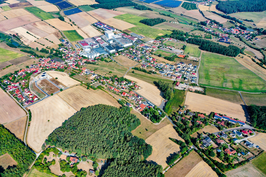Aerial view of the village of Vestenbergsgreuth featuring residential houses an industrial area and a patchwork of agricultural fields and forests Vestenbergsgreuth Bavaria Germany. Aerial view of the village of Vestenbergsgreuth featuring residential houses an industrial area and a patchwork of agricultural fields and forests Vestenbergsgreuth Bavaria Germany.