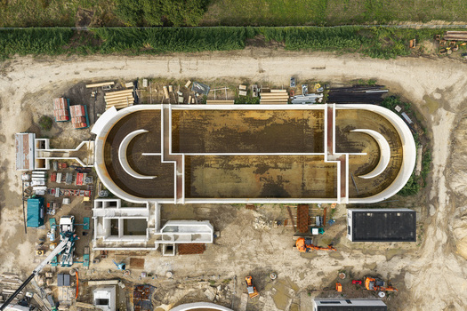 Diepenbeek Belgium 30 August 2026 Aerial view of a wastewater treatment plant under construction featuring concrete basins industrial machinery and earthworks. Diepenbeek Belgium 30 August 2026 Aerial view of a wastewater treatment plant under construction featuring concrete basins industrial machinery and earthworks.