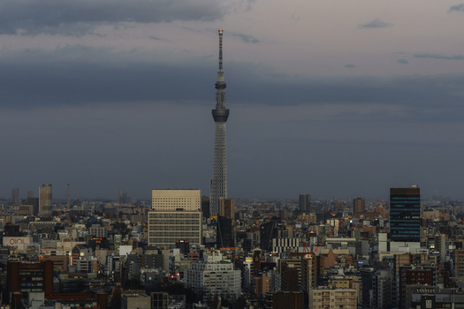 View of the Tokyo Skytree piercing the dusky skyline a modern monolith amidst a dense tapestry of urban architecture Bunkyo City Tokyo Japan. View of the Tokyo Skytree piercing the dusky skyline a modern monolith amidst a dense tapestry of urban architecture Bunkyo City Tokyo Japan.