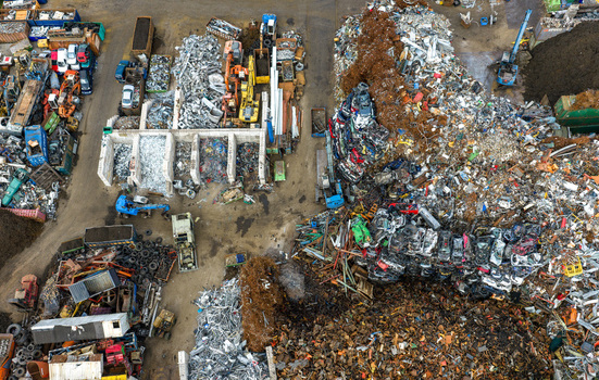 Aerial view of scrapped cars and crushed metal debris piled in a junkyard and recycling site in Hoogeveen Drenthe Netherlands. Aerial view of scrapped cars and crushed metal debris piled in a junkyard and recycling site in Hoogeveen Drenthe Netherlands.