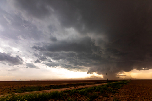 View of a dramatic supercell storm with dark swirling clouds and heavy rain over the flat plains creating a powerful atmosphere of extreme weather in Oklahoma City Oklahoma United States.