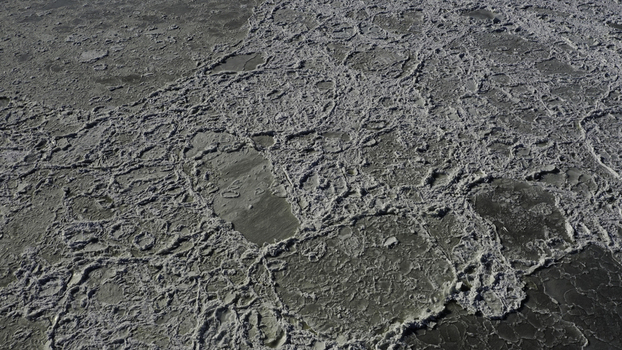 Aerial view of ice floes floating on the water surface in the winter creating a textured pattern of frozen fragments in Highlands New Jersey United States. Aerial view of ice floes floating on the water surface in the winter creating a textured pattern of frozen fragments in Highlands New Jersey United States.