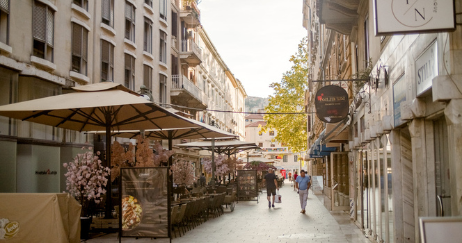 Rijeka Croatia 19 September 2026 View of a pedestrian street lined with outdoor cafe seating large umbrellas and historic buildings under a clear sky. Rijeka Croatia 19 September 2026 View of a pedestrian street lined with outdoor cafe seating large umbrellas and historic buildings under a clear sky.