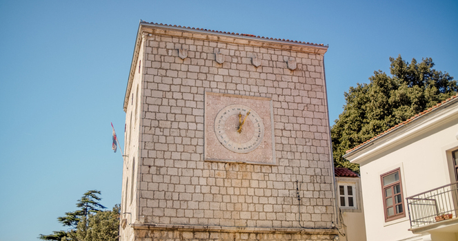 Krk Croatia 19 September 2026 View of the historic stone clock tower in the old town of Krk featuring detailed masonry and a clear blue sky. Krk Croatia 19 September 2026 View of the historic stone clock tower in the old town of Krk featuring detailed masonry and a clear blue sky.