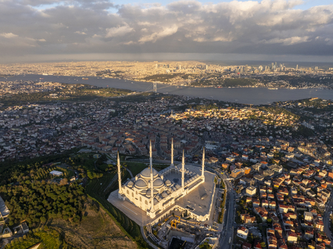 Aerial view of Grand Camlica Mosque with its prominent minarets and dome overlooking the sprawling urban landscape and the Bosphorus strait in Uskudar Istanbul Turkey. Aerial view of Grand Camlica Mosque with its prominent minarets and dome overlooking the sprawling urban landscape and the Bosphorus strait in Uskudar Istanbul Turkey.
