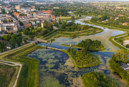 Aerial view of the historic fortifications and canal system surrounded by lush greenery and city buildings in Gdansk Pomeranian Voivodeship Poland. Aerial view of the historic fortifications and canal system surrounded by lush greenery and city buildings in Gdansk Pomeranian Voivodeship Poland.