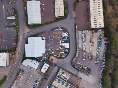 Aerial view of an industrial area with buildings parked vehicles and organized material storage Stafford England United Kingdom. Aerial view of an industrial area with buildings parked vehicles and organized material storage Stafford England United Kingdom.