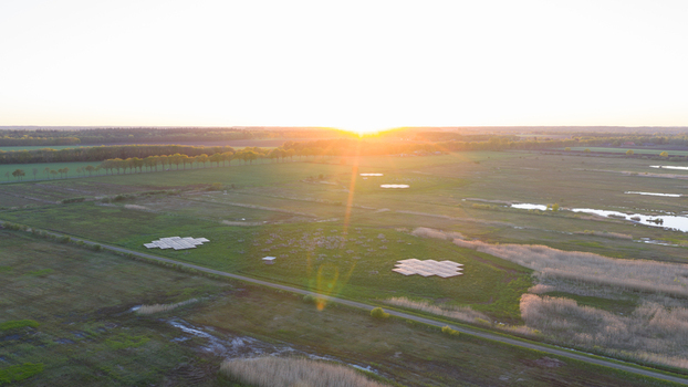 Aerial view of the LOFAR superterp radio telescope antennas situated in green fields under a golden sunset Buinen Drenthe Netherlands. Aerial view of the LOFAR superterp radio telescope antennas situated in green fields under a golden sunset Buinen Drenthe Netherlands.