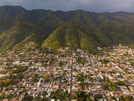 Aerial view of the town of Ajijic nestled at the base of the Sierra Madre mountains with colorful rooftops and lush vegetation in Ajijic Jalisco Mexico. Aerial view of the town of Ajijic nestled at the base of the Sierra Madre mountains with colorful rooftops and lush vegetation in Ajijic Jalisco Mexico.